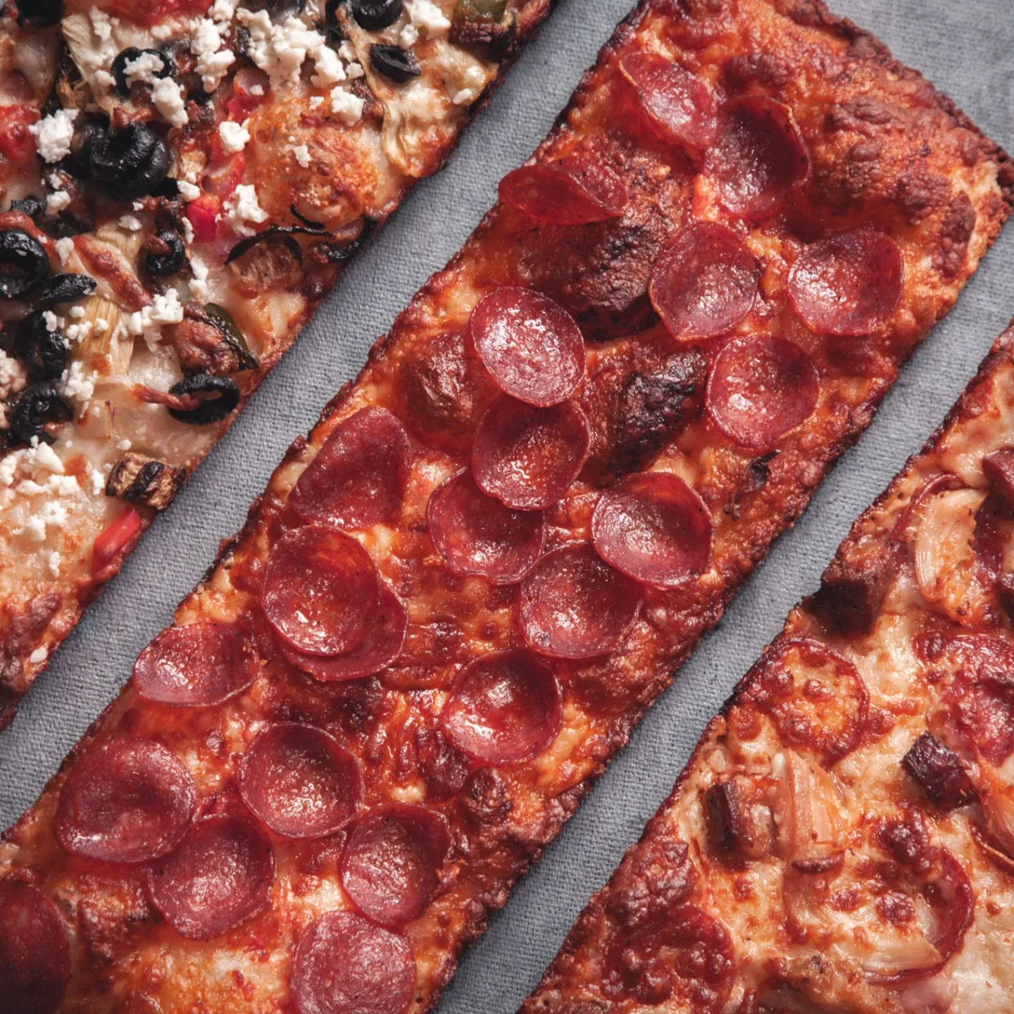 Detroit-style pizza strips: vegi with feta and olives, pepperoni, and BBQ chicken